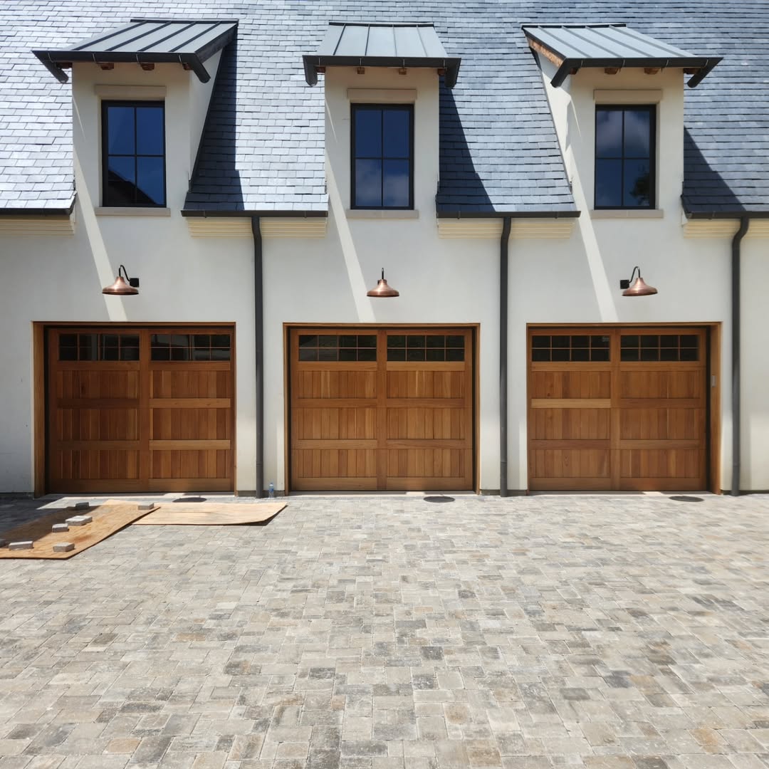Three-car natural cedar carriage style wood garage doors