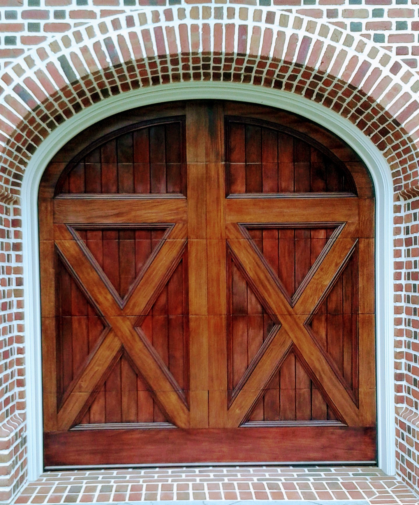 Arched mahogany X-brace custom wood garage door